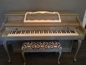 upright piano with matching bench